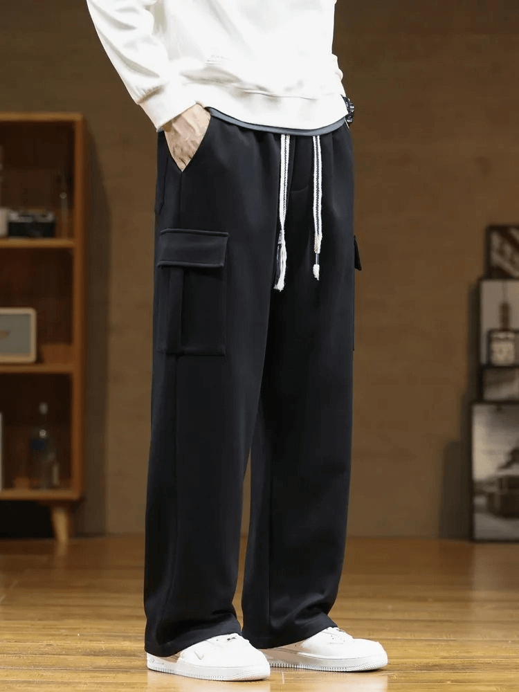 Stylish men's sports pants with multiple pockets, loose fit, midrise waist in black, made of polyester and cotton. SF1977 model.